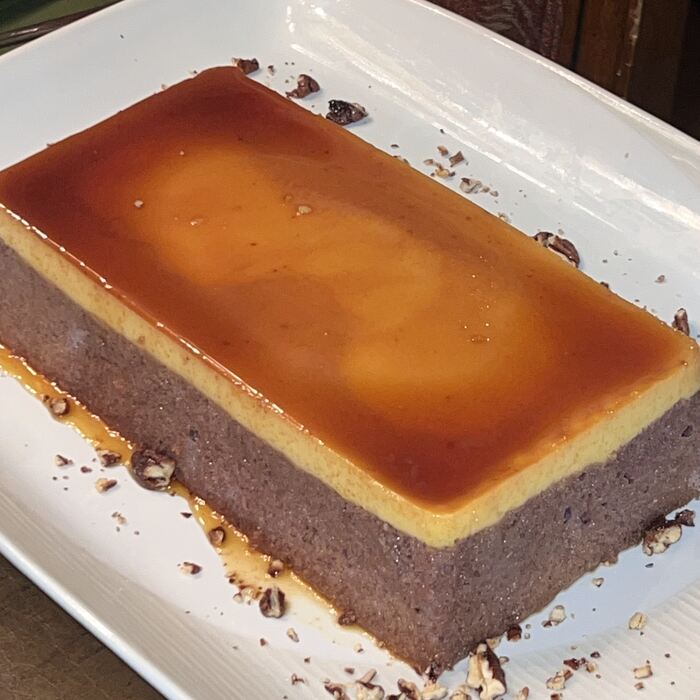 An ube leche flan on a white platter