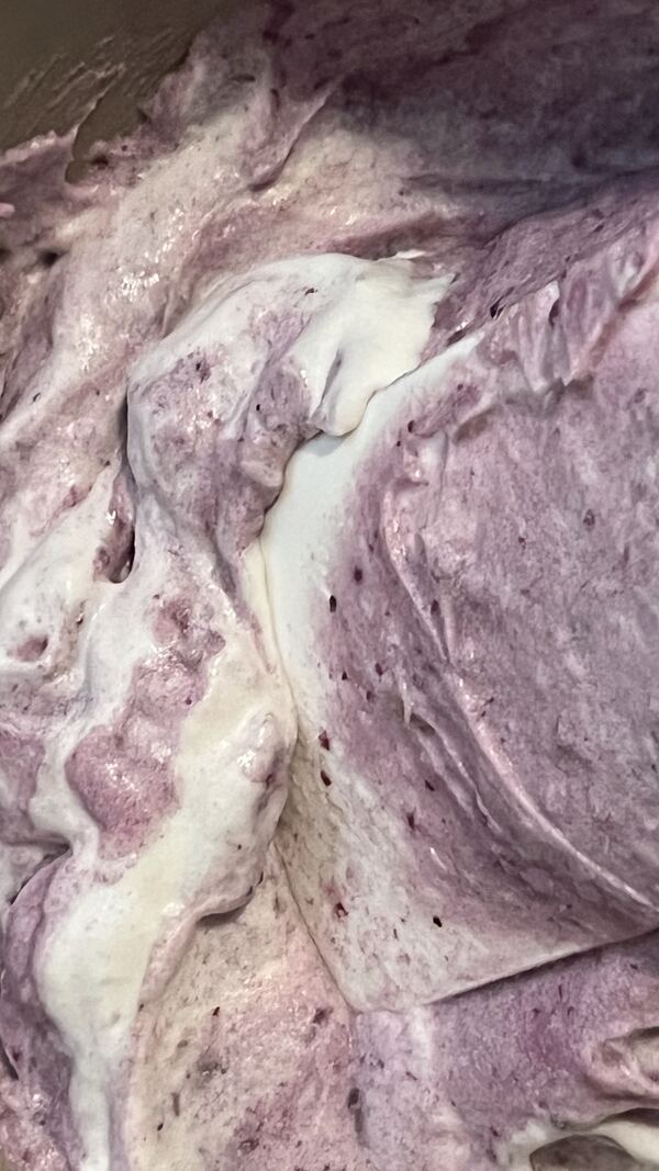 Ube halaya cooking down in a steel pot